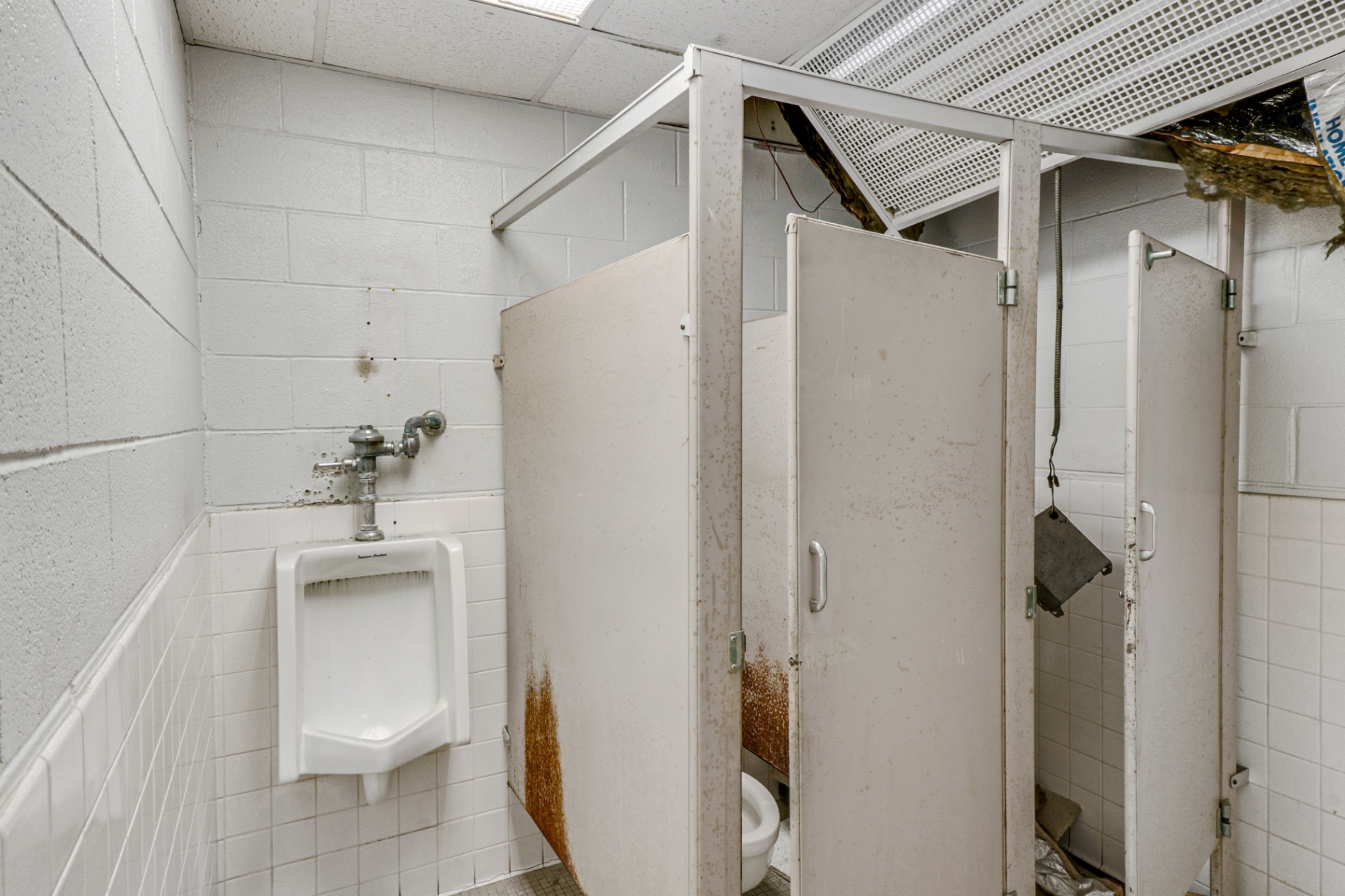 Original restroom stalls and urinal